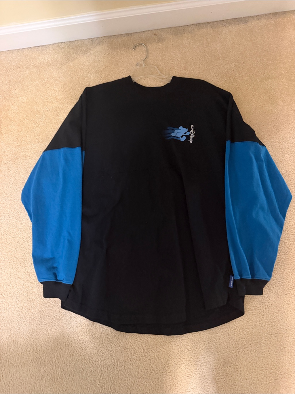 A runDisney spirit jersey photographed for a US resale marketplace listing in September 2026